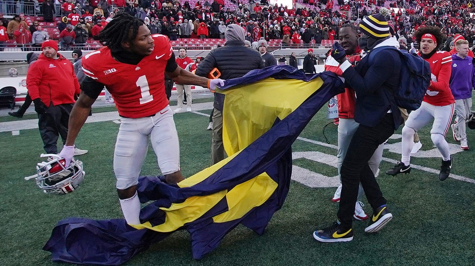 Michigan's shocking upset over Ohio State erupts into chaos as massive brawl breaks out at midfield