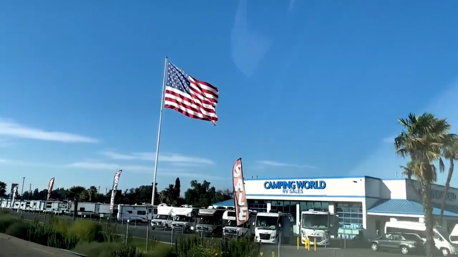 Camping World CEO defies another city's threat of legal action over huge American flag: Not 'coming down'