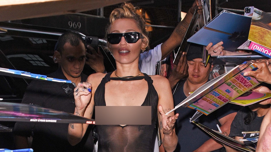 Miley Cyrus stuns fans in daring dress during New York album signing