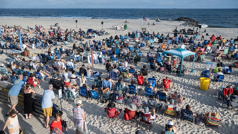 Popular beach town brings Sunday Mass to shore so faithful don't miss sermon or surf