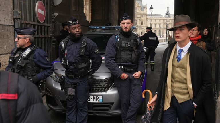 Mystery man in dapper suit goes viral after appearing in Louvre heist investigation photo