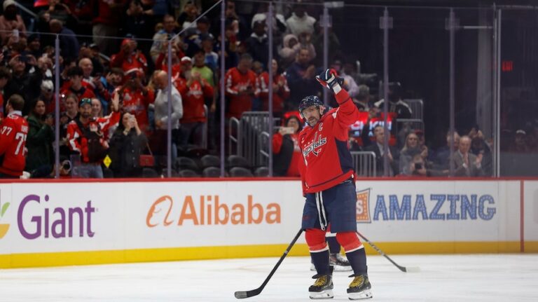 Alex Ovechkin becomes first NHL player to reach 900 goals as opposing goalie tries to hide milestone puck