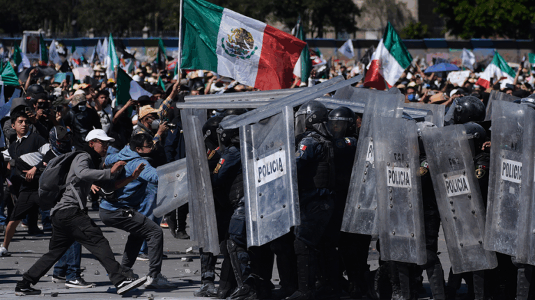 More than 100 officers injured as protesters attack police, breach barrier at Mexico's National Palace