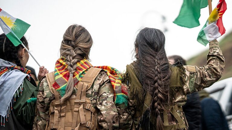 Syrian militiaman shows off what he claims to be severed Kurdish fighter's braid as Damascus asserts control